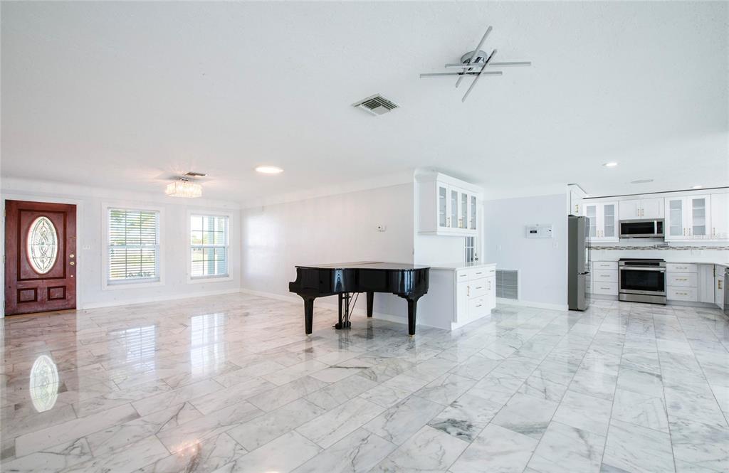 551 Crystal Drive Madeira Beach, FL 33708 - Photo 30 of 46 a view of a kitchen with furniture and a fireplace