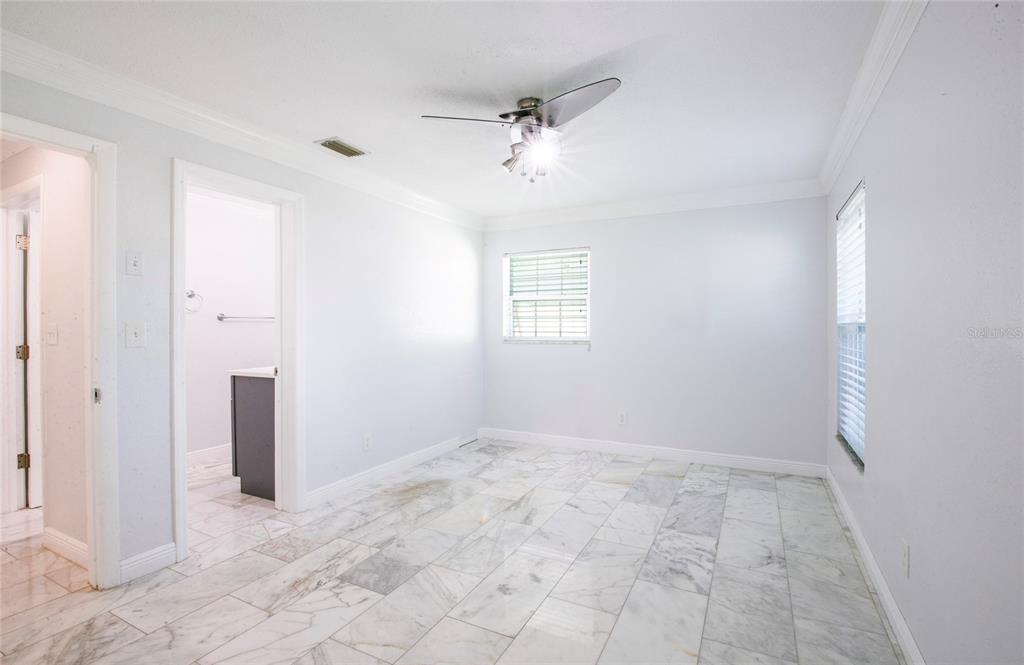 551 Crystal Drive Madeira Beach, FL 33708 - Photo 34 of 46 an empty room with windows and a ceiling fan