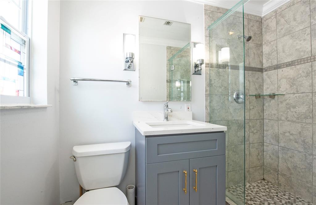 551 Crystal Drive Madeira Beach, FL 33708 - Photo 36 of 46 a bathroom with a toilet sink and shower