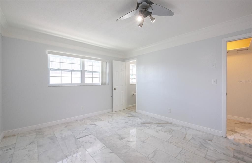 551 Crystal Drive Madeira Beach, FL 33708 - Photo 38 of 46 an empty room with windows and fan