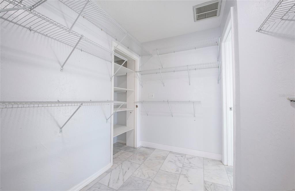 551 Crystal Drive Madeira Beach, FL 33708 - Photo 43 of 46 a view of walk in closet with empty racks