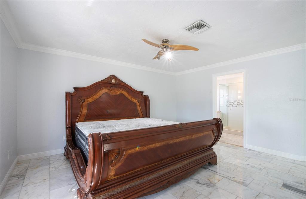 551 Crystal Drive Madeira Beach, FL 33708 - Photo 45 of 46 a bedroom with a bed and cabinet