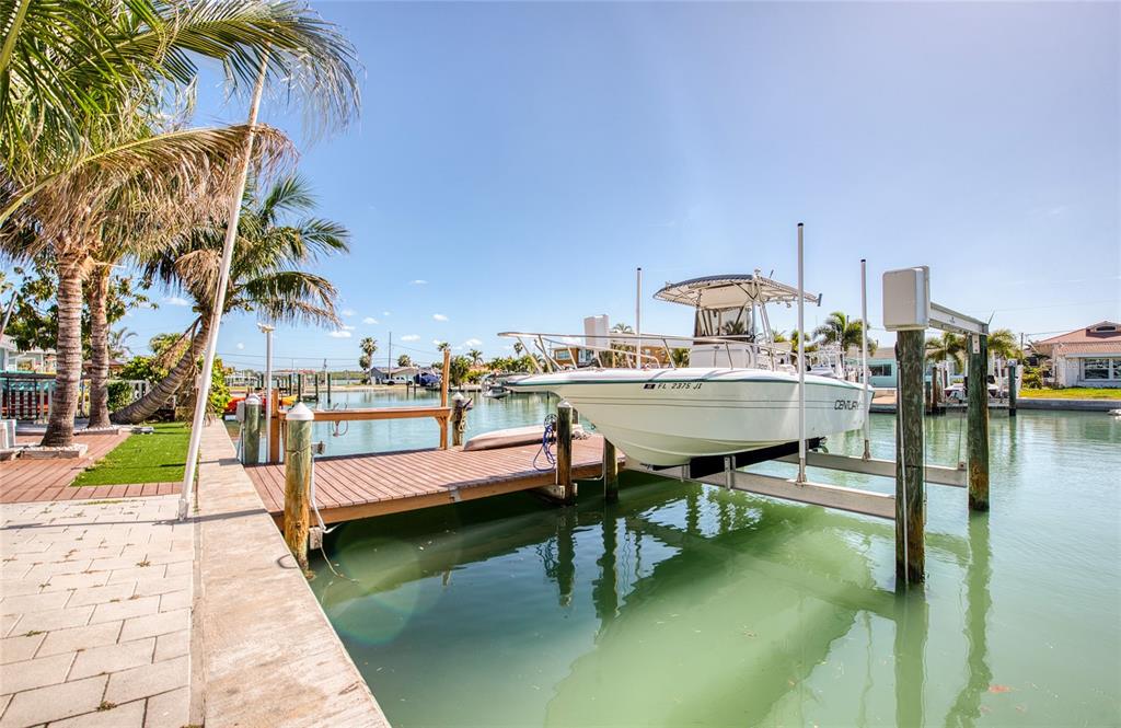 551 Crystal Drive Madeira Beach, FL 33708 - Photo 7 of 46 a view of a swimming pool with a lounge chairs