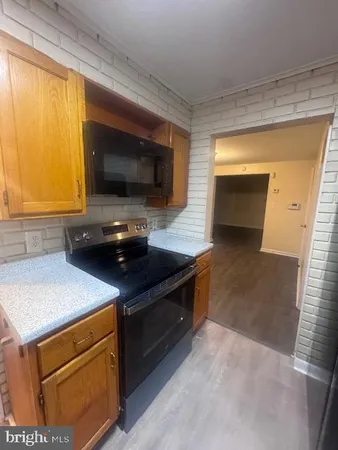 a kitchen with a sink and a stove top oven