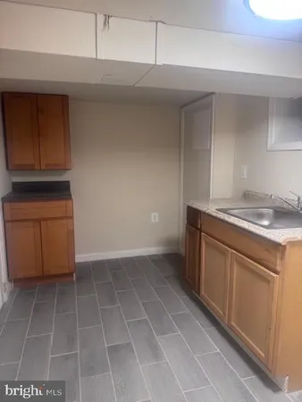 a kitchen with a sink a stove and cabinets