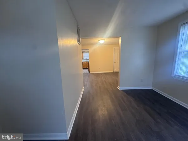 a view of a room with wooden floor