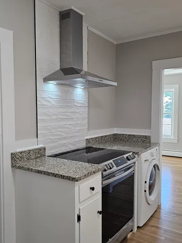 a stove top oven sitting inside of a kitchen