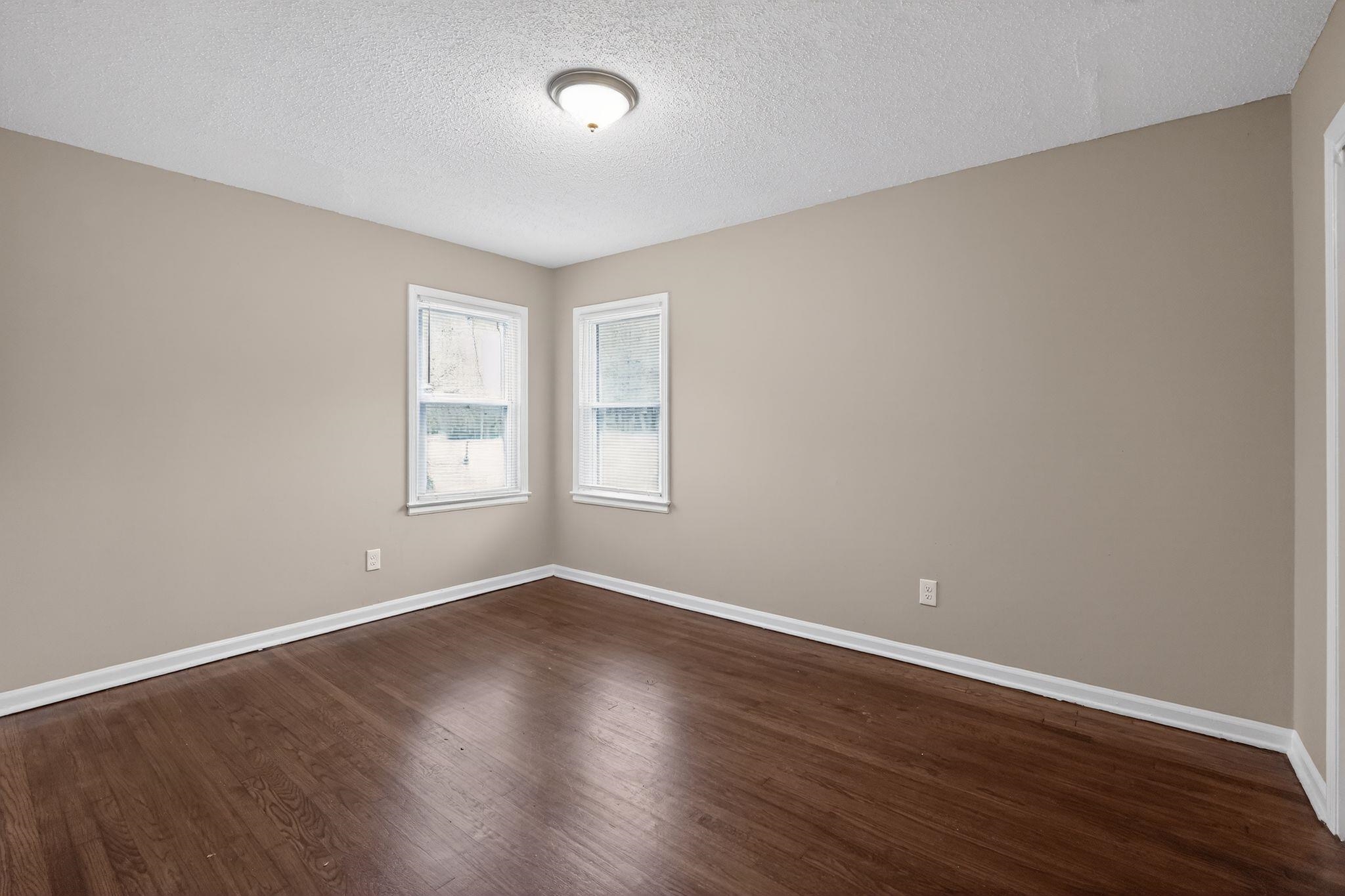 4689 Raleigh Lagrange Road Memphis, TN 38128 - Photo 17 of 30 Unfurnished room with a textured ceiling and dark wood-type flooring