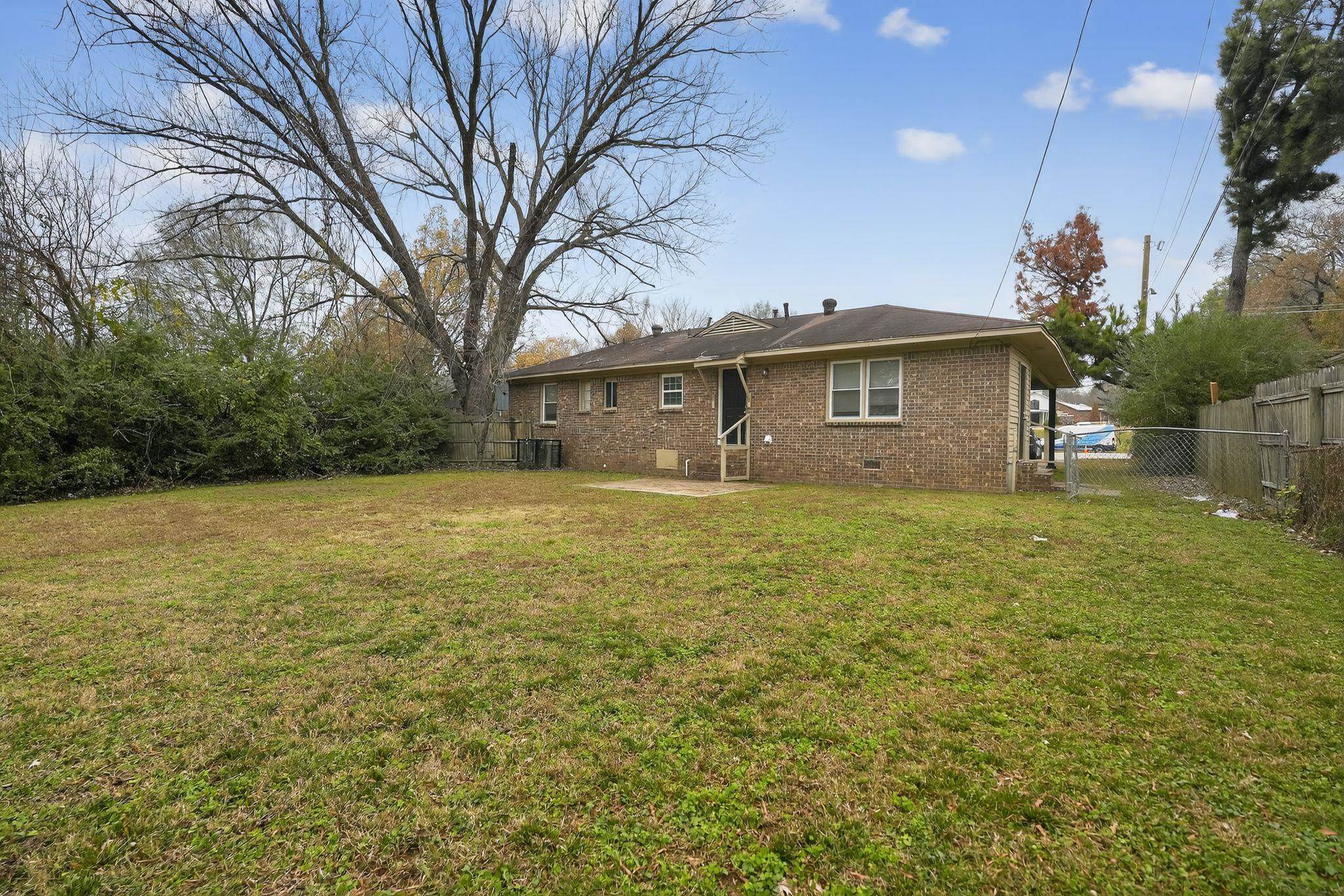 4689 Raleigh Lagrange Road Memphis, TN 38128 - Photo 28 of 30 Back of house featuring crawl space, a fenced backyard, brick siding, and a patio area