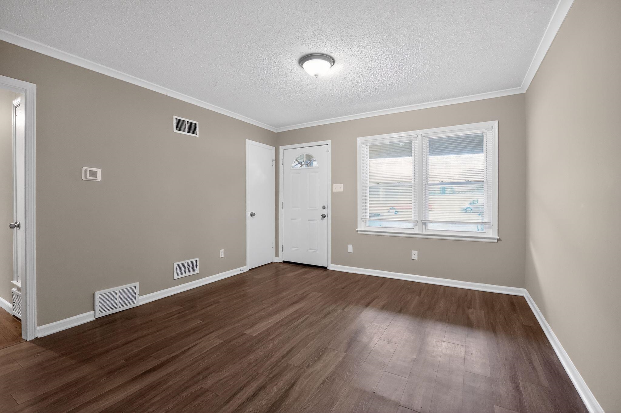 4689 Raleigh Lagrange Road Memphis, TN 38128 - Photo 4 of 30 Entrance foyer featuring a textured ceiling, ornamental molding, and dark wood finished floors