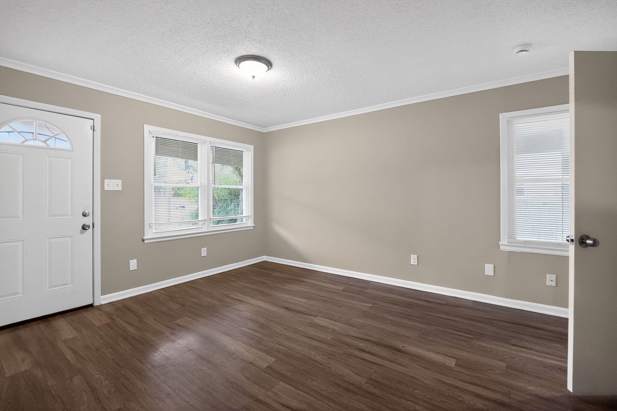 4689 Raleigh Lagrange Road Memphis, TN 38128 - Photo 5 of 30 Entryway featuring a textured ceiling, dark wood-style flooring, and crown molding