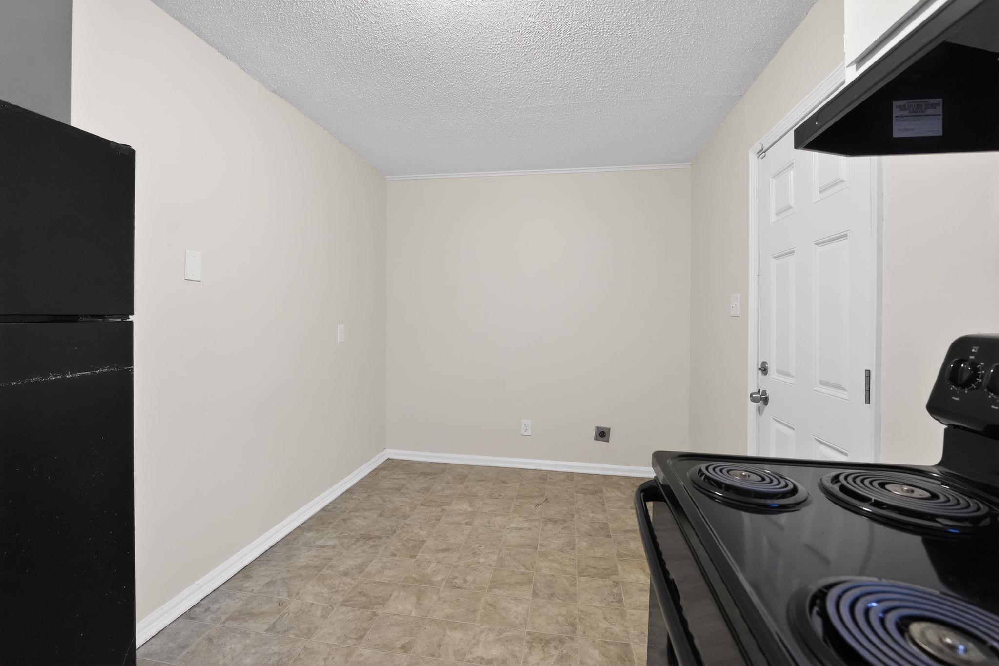 4689 Raleigh Lagrange Road Memphis, TN 38128 - Photo 8 of 30 Kitchen featuring black appliances, exhaust hood, and a textured ceiling