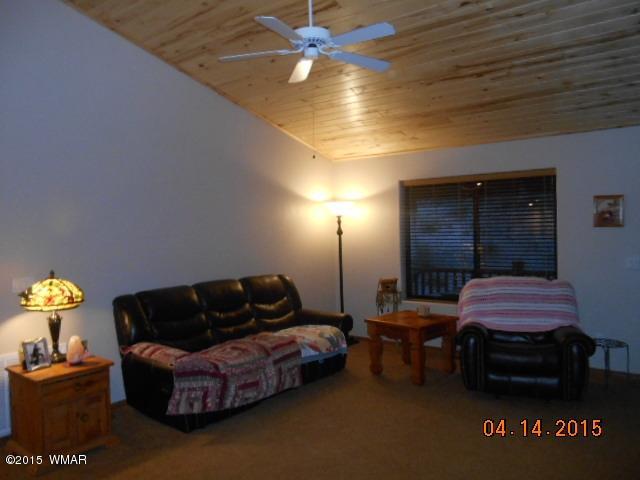 4890 West Cottage Loop Show Low, AZ 85901 - Photo 11 of 28 a living room with furniture and a lamp