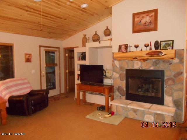 4890 West Cottage Loop Show Low, AZ 85901 - Photo 12 of 28 a living room with furniture and a fireplace