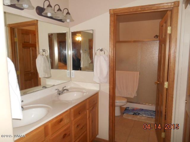 4890 West Cottage Loop Show Low, AZ 85901 - Photo 20 of 28 a bathroom with a sink and a mirror