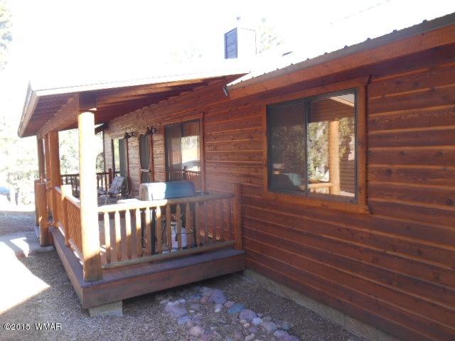 4890 West Cottage Loop Show Low, AZ 85901 - Photo 4 of 28 a view of a house with porch and wooden floor
