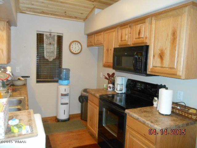 4890 West Cottage Loop Show Low, AZ 85901 - Photo 5 of 28 a kitchen with stainless steel appliances granite countertop a stove a sink and a microwave