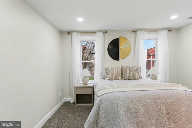 a bedroom with a large bed and a painting