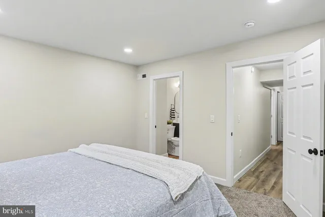 a bedroom with a bed and a bathroom