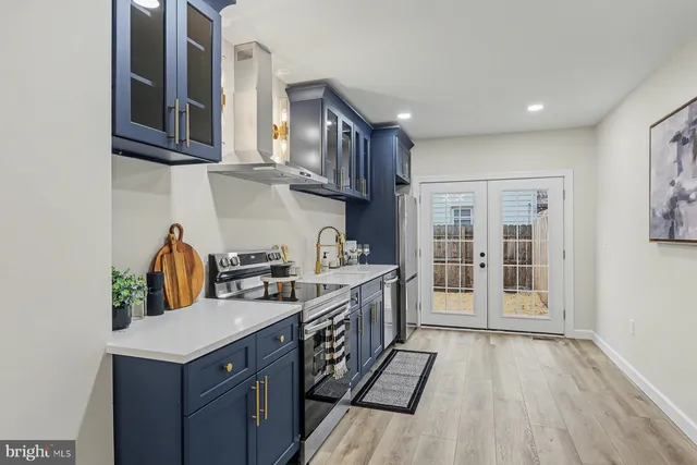 a kitchen with stainless steel appliances granite countertop a stove and a refrigerator