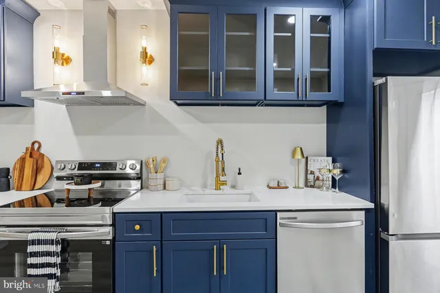 a kitchen with a sink a stove and cabinets