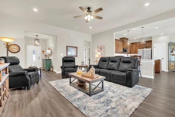 a kitchen with stainless steel appliances kitchen island granite countertop a sink stove and microwave