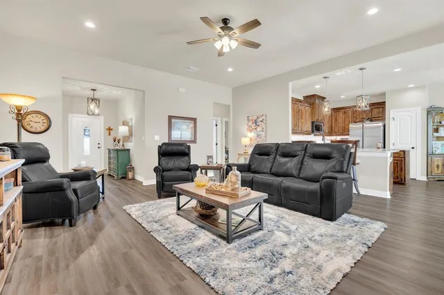 a kitchen with stainless steel appliances kitchen island granite countertop a sink stove and microwave
