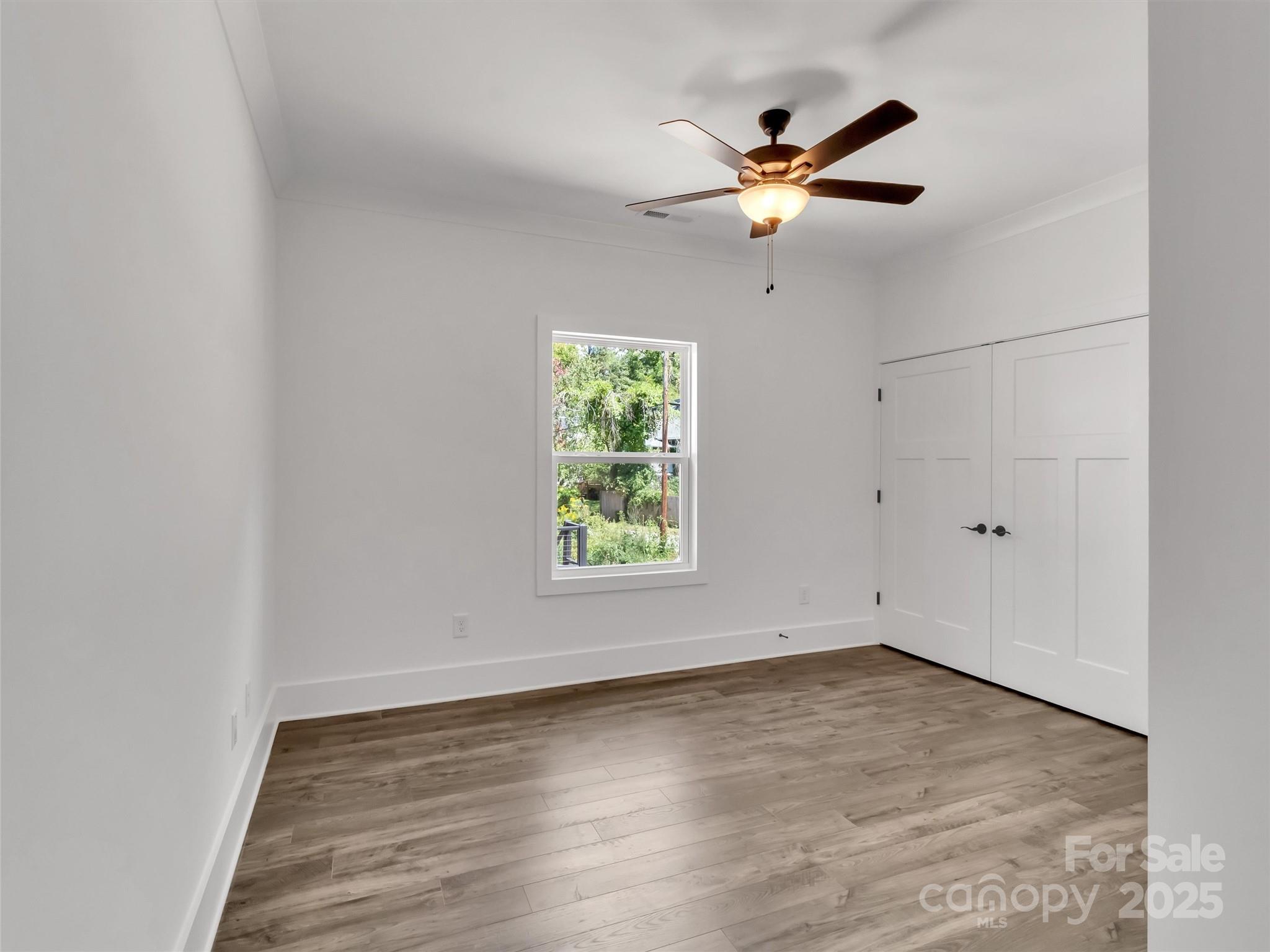 12 Whitson Road Asheville, NC 28805 - Photo 13 of 18 an empty room with wooden floor and windows