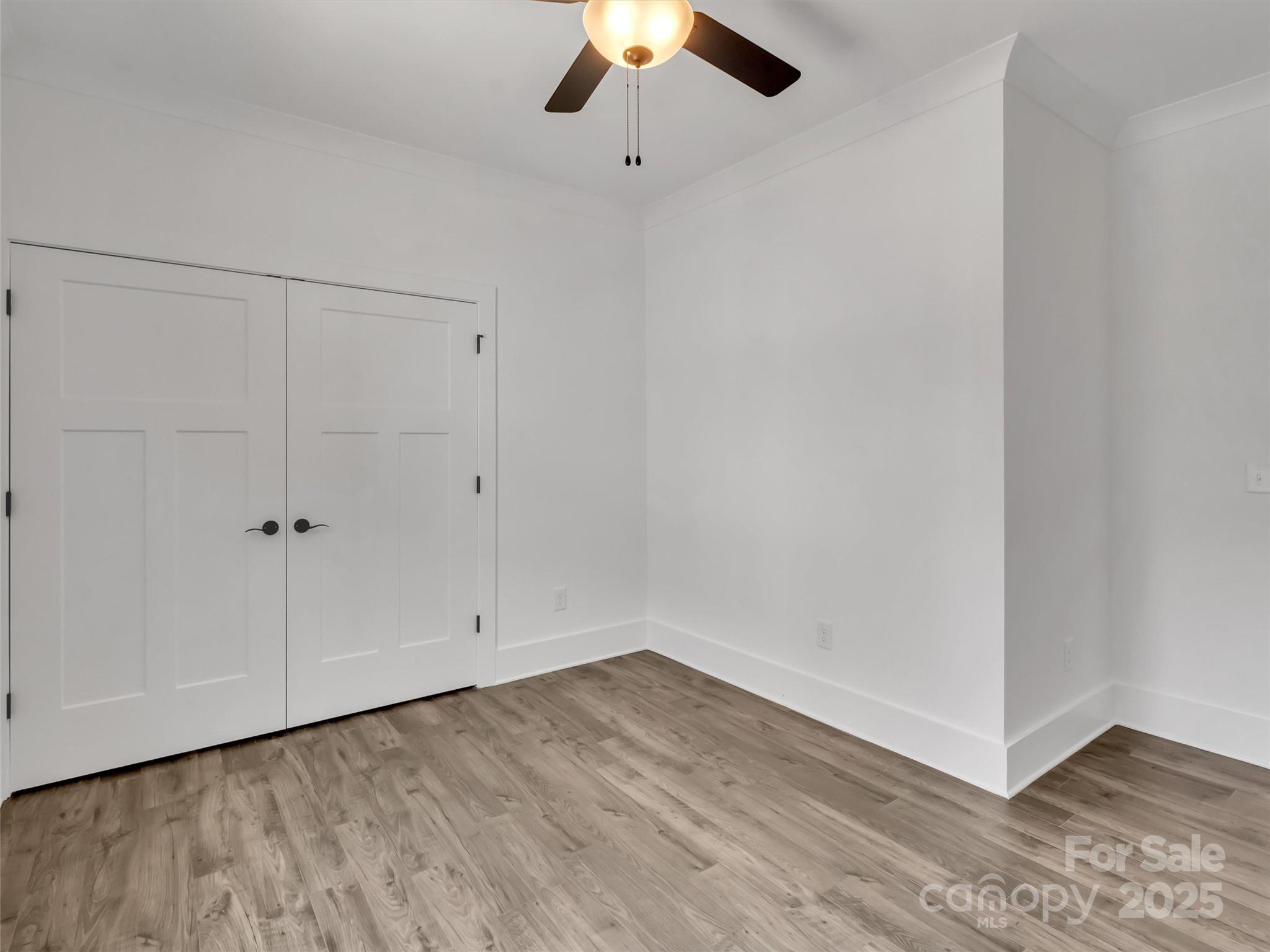 12 Whitson Road Asheville, NC 28805 - Photo 14 of 18 a view of an empty room with a chandelier fan