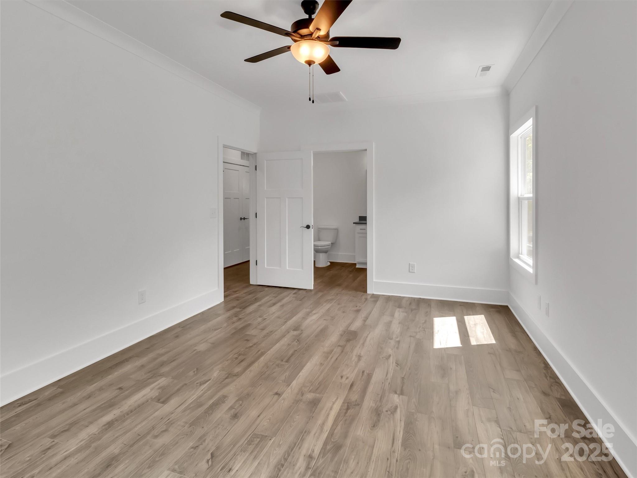 12 Whitson Road Asheville, NC 28805 - Photo 9 of 18 a view of empty room with wooden floor and fan