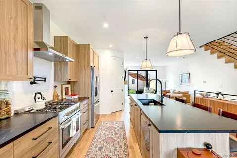 a kitchen with sink a stove and cabinets