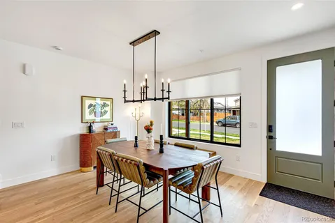 a dining room with furniture and wooden floor