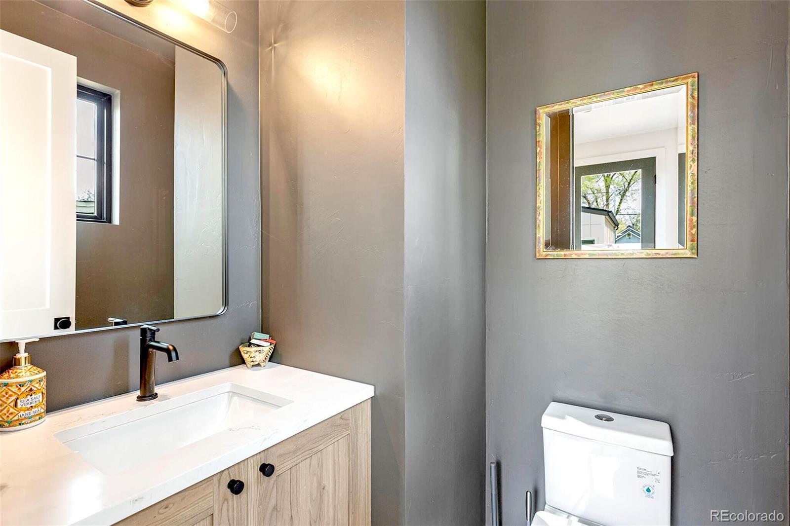 2455 Chase Street Edgewater, CO 80214 - Photo 17 of 46 a bathroom with a sink and a mirror