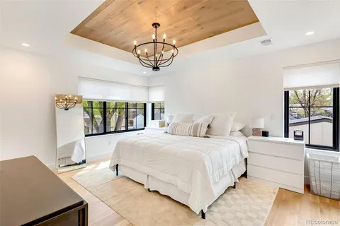 a bedroom with a bed and a chandelier