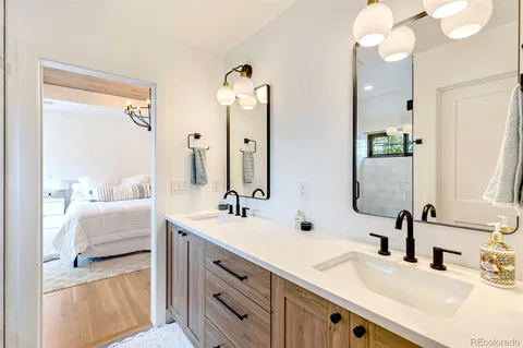 a bathroom with a double vanity sink a mirror a shower and a bathtub