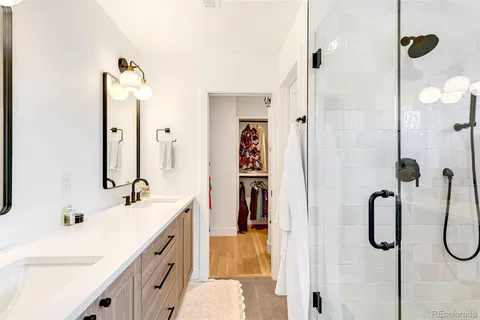 a view of walk in closet with clothes and shoes