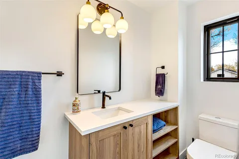 a bathroom with a sink vanity and shower