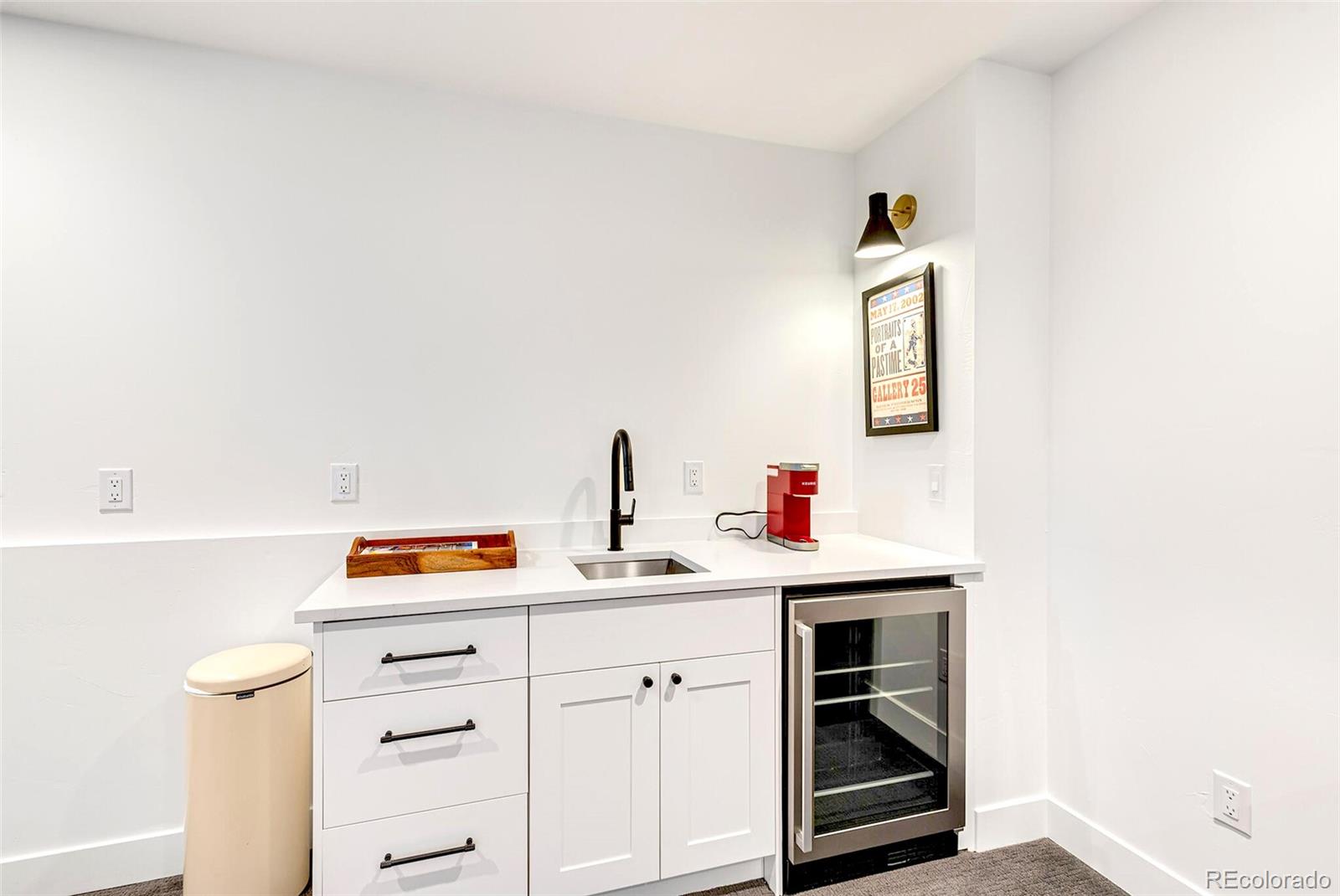 2455 Chase Street Edgewater, CO 80214 - Photo 32 of 46 a utility room with cabinets and window