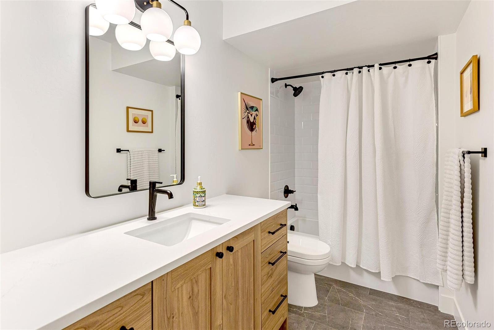 2455 Chase Street Edgewater, CO 80214 - Photo 33 of 46 a bathroom with a sink a toilet and a mirror