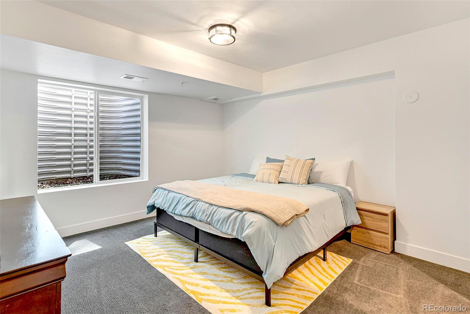 2455 Chase Street Edgewater, CO 80214 - Photo 34 of 46 a bedroom with a bed and window