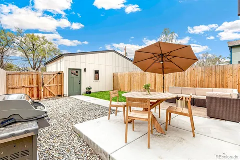 a view of a house with a yard and sitting area
