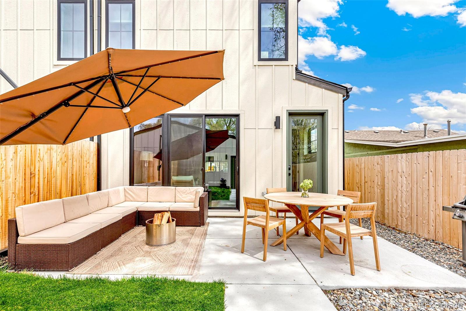 2455 Chase Street Edgewater, CO 80214 - Photo 39 of 46 a view of a patio with a table and chairs under an umbrella