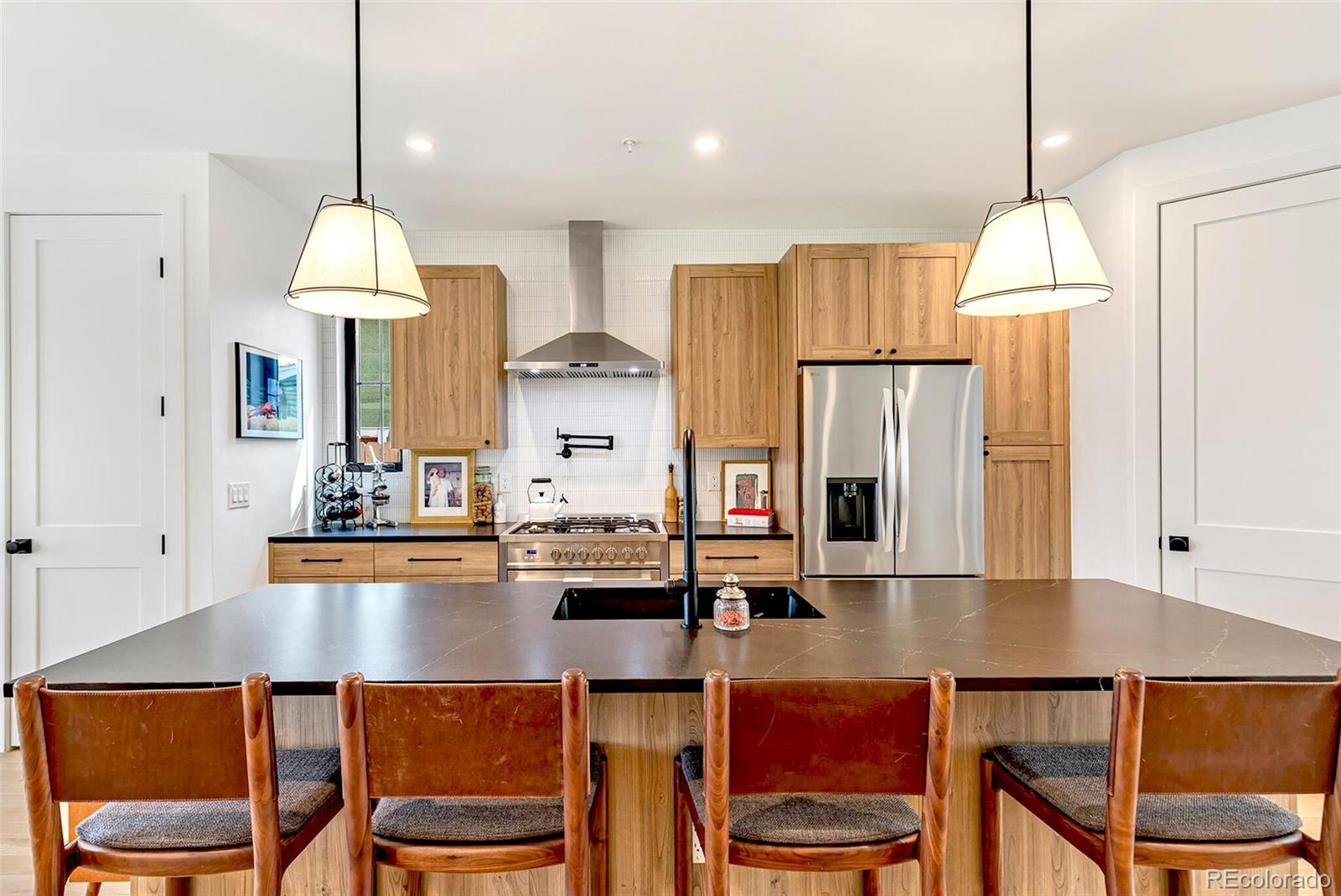 2455 Chase Street Edgewater, CO 80214 - Photo 9 of 46 a dining table chairs and a refrigerator in kitchen