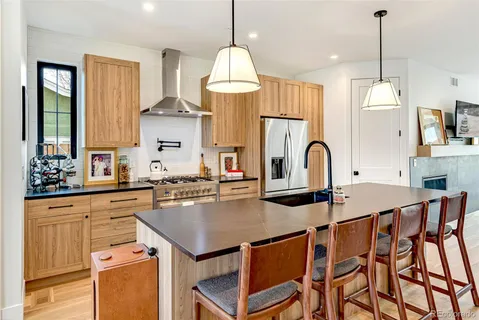 a kitchen with a table chairs stove and cabinets
