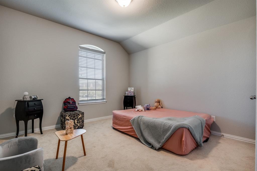 1316 Torrington Lane Forney, TX 75126 - Photo 24 of 36 a bedroom with a bed and wooden floor