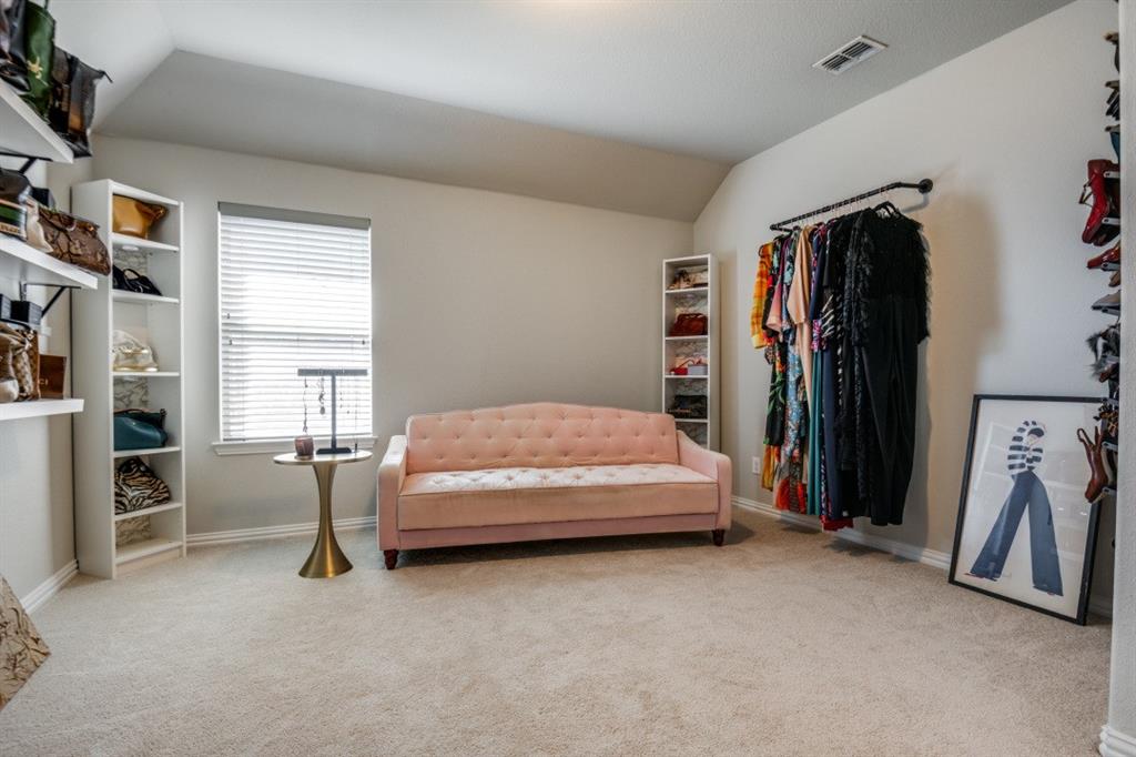 1316 Torrington Lane Forney, TX 75126 - Photo 26 of 36 a bedroom with a bed and a walk in closet