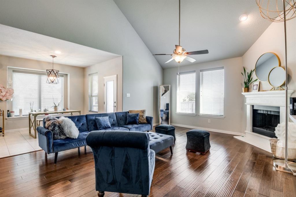 1316 Torrington Lane Forney, TX 75126 - Photo 8 of 36 a living room with furniture a fireplace and a chandelier