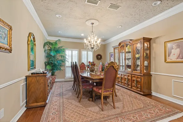 a view of a dining room with furniture and chandelier