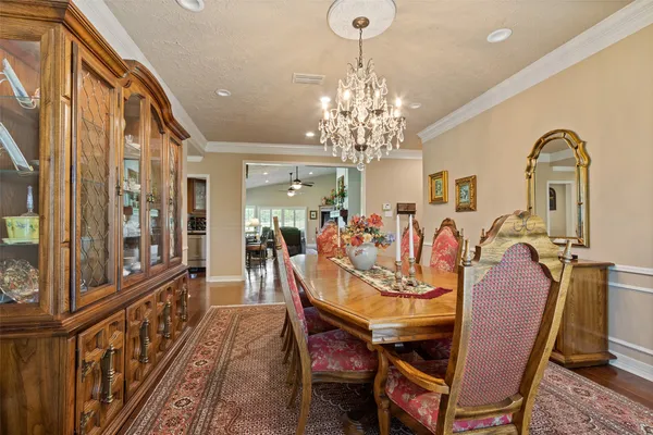 a view of a dining room with furniture and chandelier