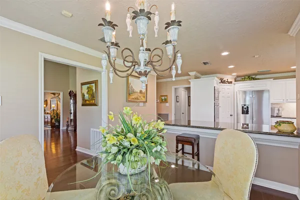 a dining room with furniture and chandelier
